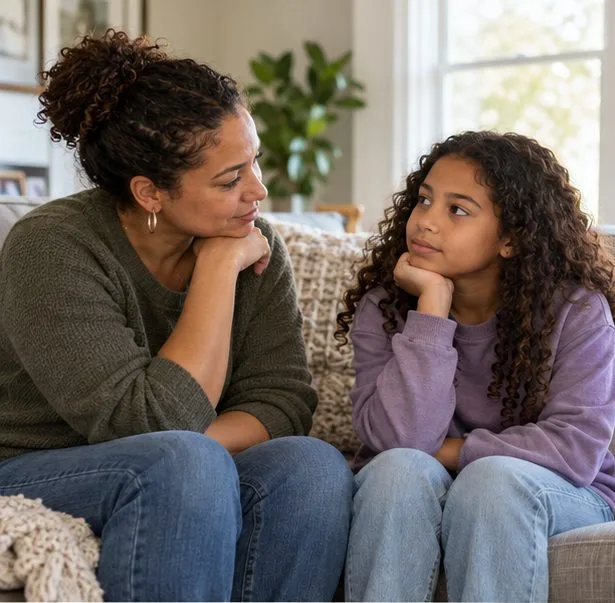 A parent sits at the child’s eye level and listens as the child pauses to think.